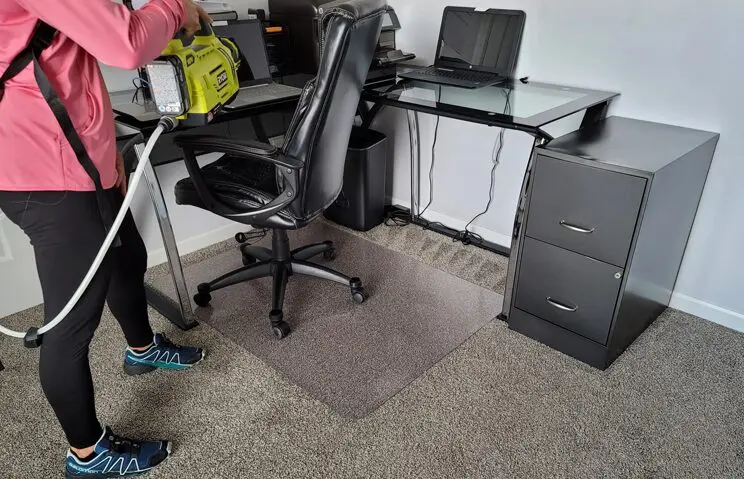 A person standing in front of an office desk.